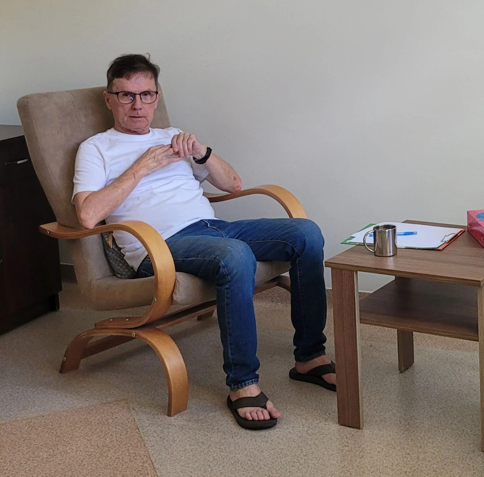 Andrzej Wojciechowski siedzi w fotelu w swoim gabinecie psychoterapii w Olsztynie